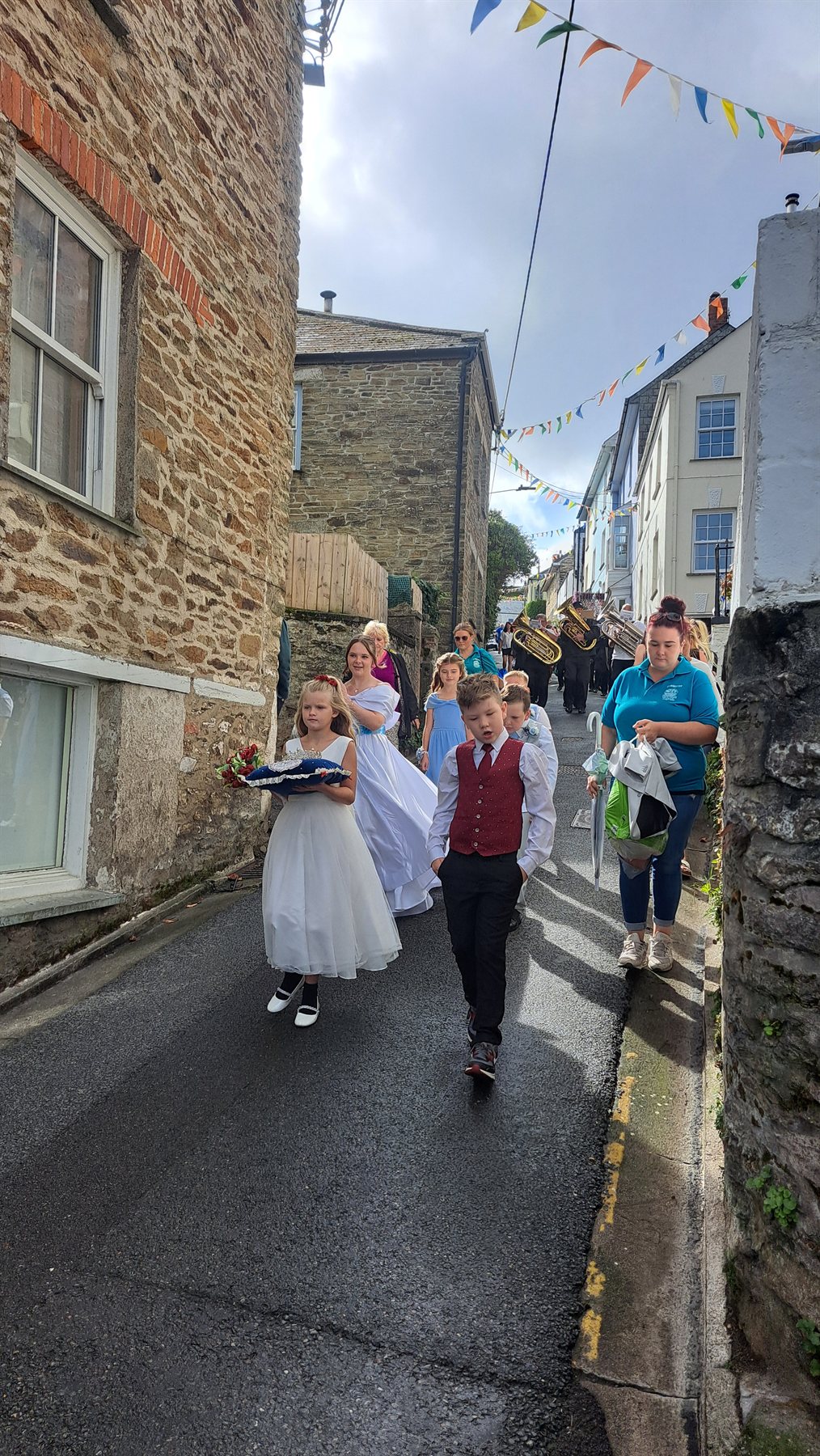 Polruan Regatta Royalty procession passing through the bunting-lined village street